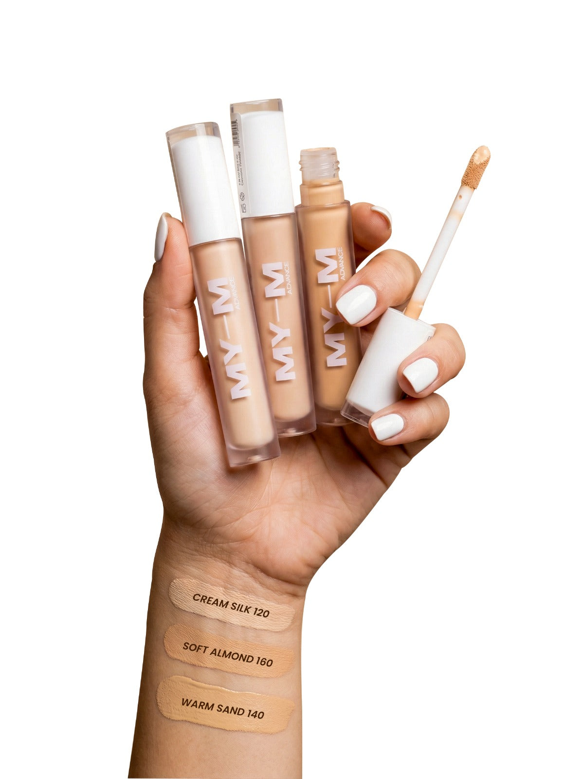 Hand holding 3 types of MYM concealer tubes with swatches