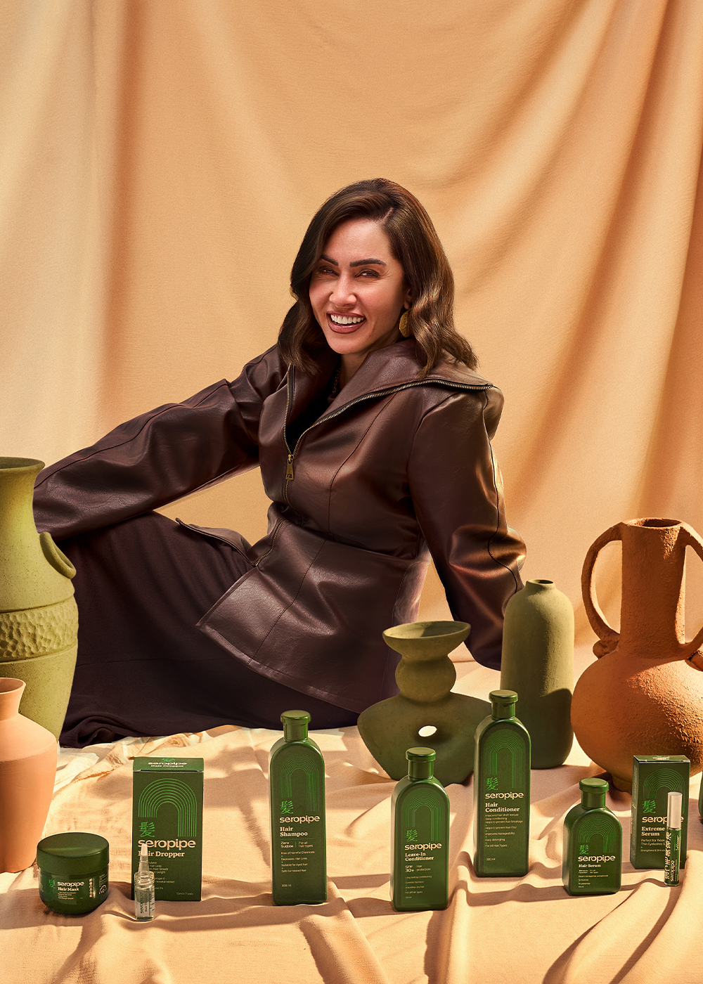 Woman posing with seropipe hair care products.
