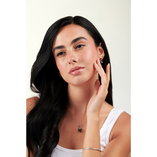 MY-M-ADVANCE Woman with long dark hair wearing a white top 