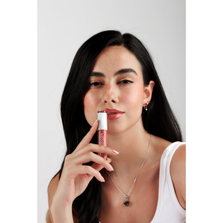 MY-M-ADVANCE Woman holding a lip gloss 
