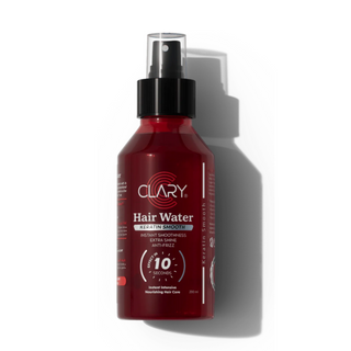 A bottle of Clary Hair Water with a spray nozzle, predominantly red in color with product information