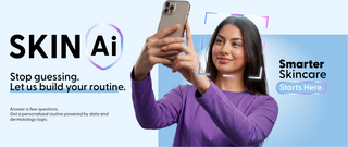 Woman taking a selfie with a phone, promoting Skin AI skincare routine.