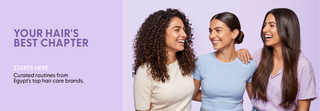 Three women with different hair types standing together promoting hair care products.