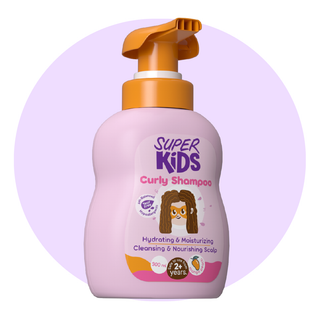 A bottle of Superkids Curly Hair Shampoo with a pink label and an orange pump. The shampoo is marketed for hydrating and nourishing curly hair.