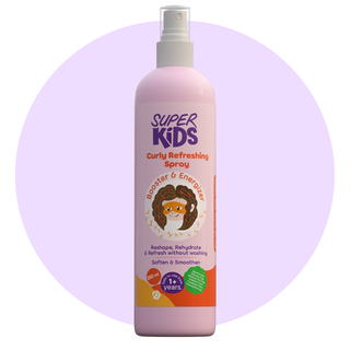 A bottle of SuperKids Curly Refreshing Spray with a pink label and a cartoon character illustration. The label includes text describing the product as a hydrating spray for curls and waves.