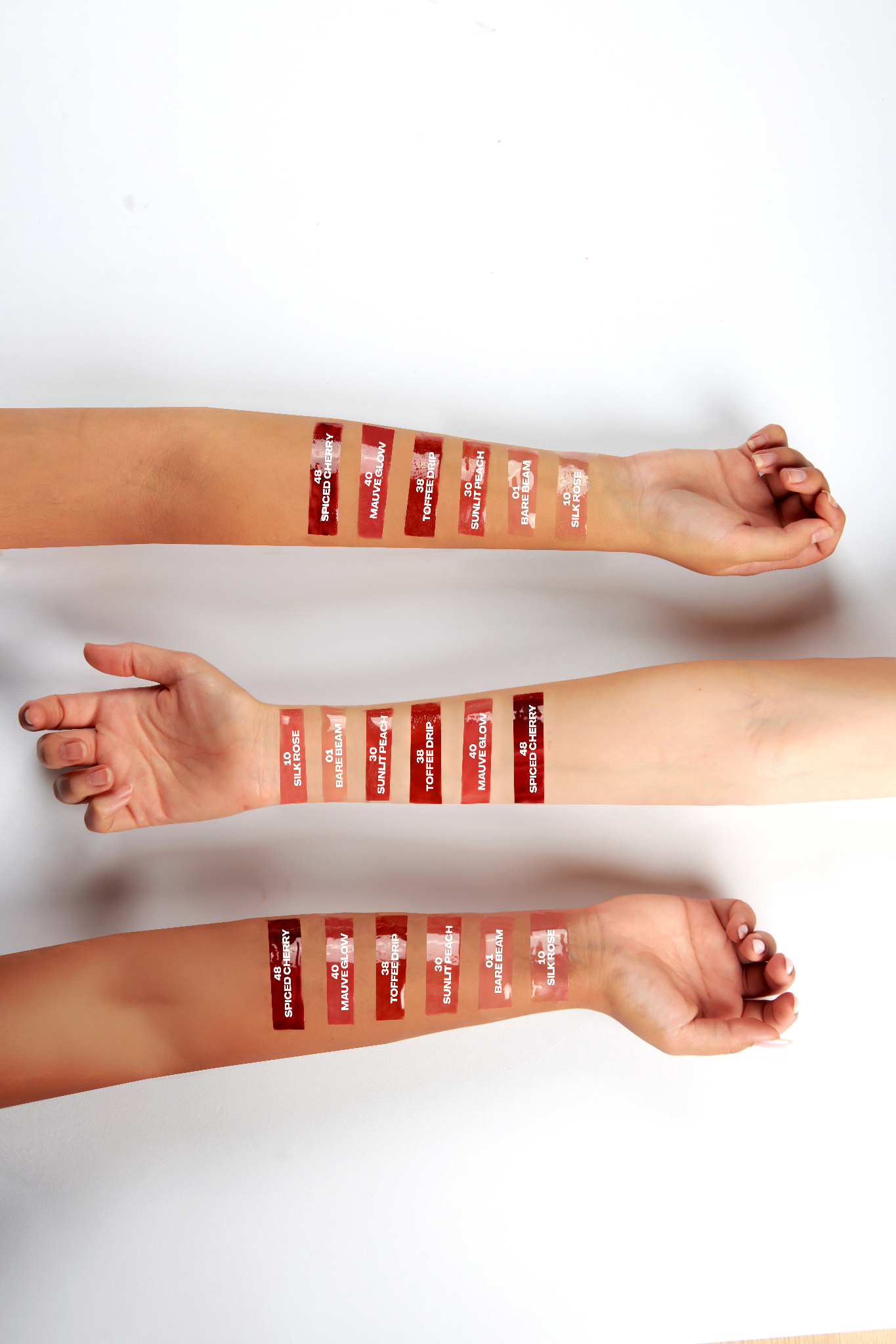 Lipstick swatches on a person's arm 