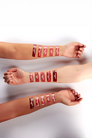 Lipstick swatches on a person's arm 