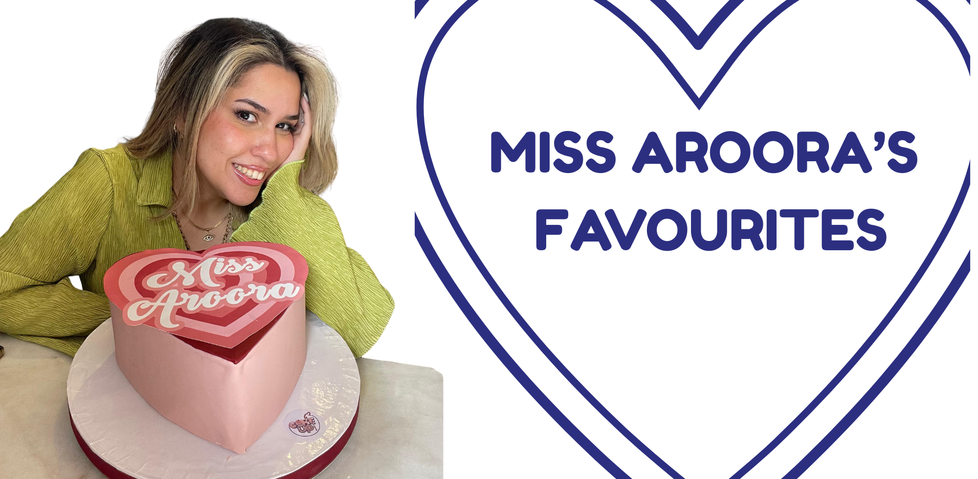Woman with a heart-shaped cake featuring 'Miss Aroora'