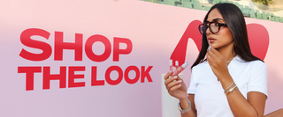 Woman holding makeup products with 'Shop the Look'.