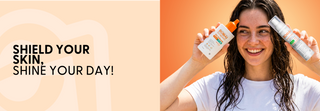 Woman holding sunscreen bottles with promotional 'shield your skin, shine your day.'