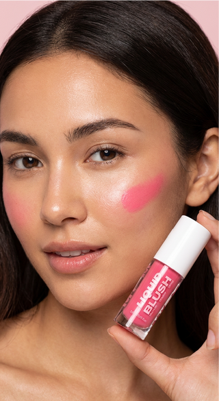 Woman holding a liquid blush product with a pink blush on her cheek